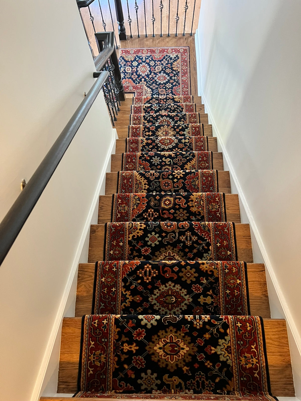 Staircase with Serai rugs on wooden steps