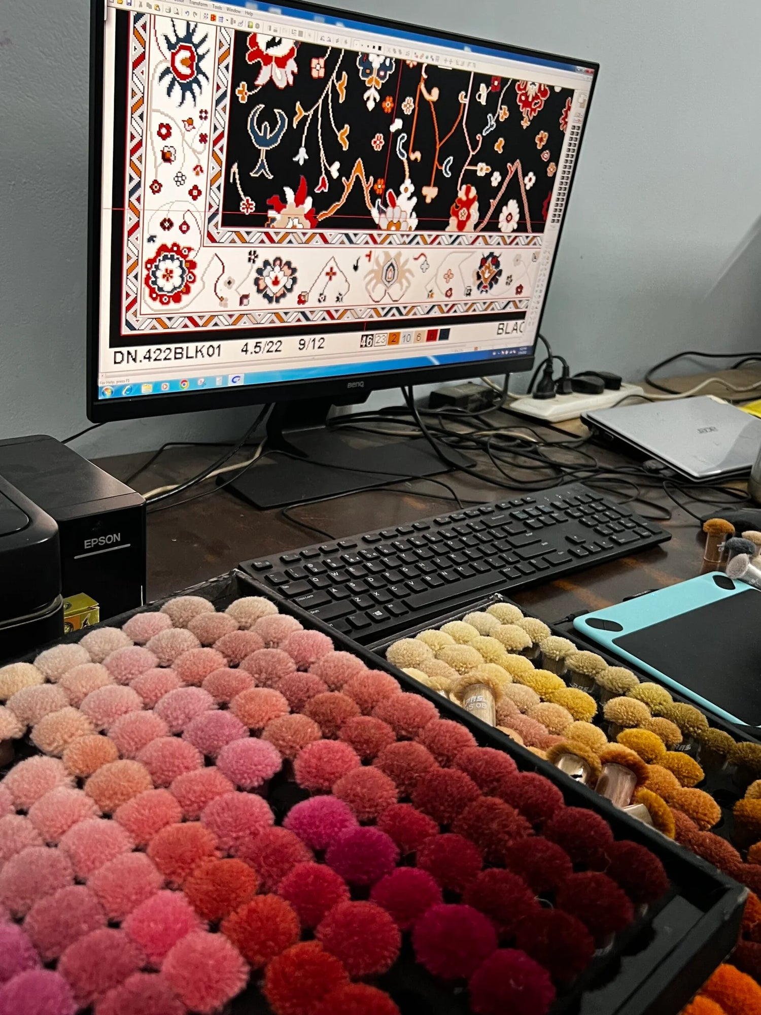 image shows the computer showing the CAD work progress with colors poms to finalize colors 