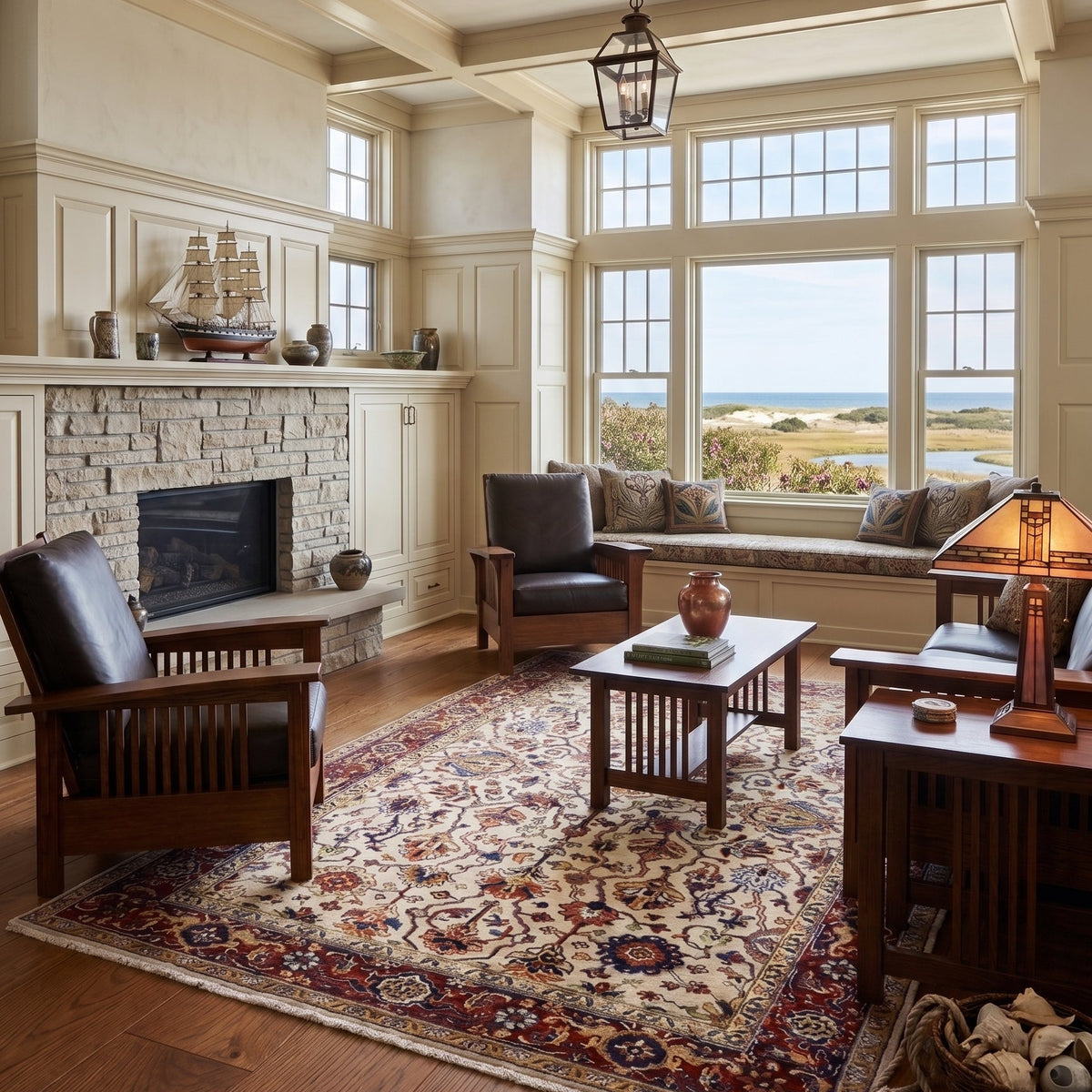 A large, elegant living room with a high coffered ceiling, featuring a traditional oriental area rug, dark wood furniture, a stone fireplace, and a bay window overlooking a scenic landscape.